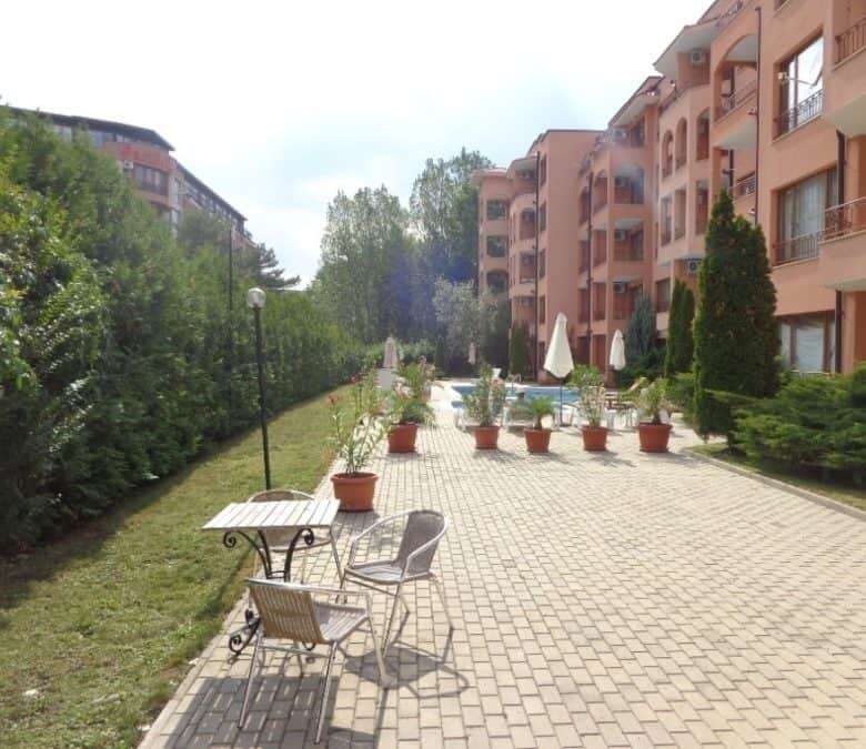 Outdoor courtyard of Sunflower apartment complex with seating and landscaped gardens.