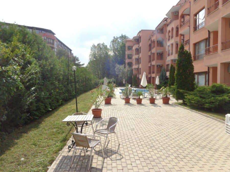 Outdoor courtyard of Sunflower apartment complex with seating and landscaped gardens.