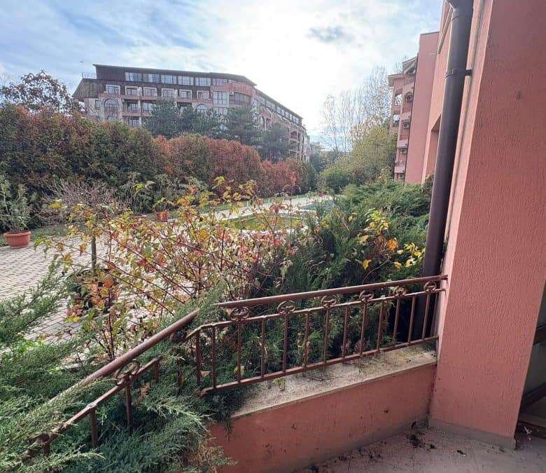 Cozy balcony view of lush greenery and nearby residential buildings in Sunny Beach, just 450 meters.