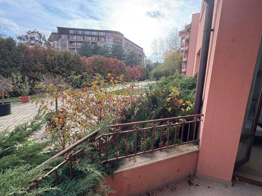 Cozy balcony view of lush greenery and nearby residential buildings in Sunny Beach, just 450 meters.