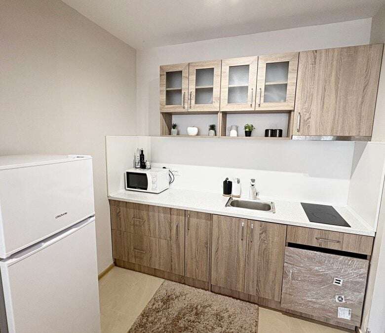 Bright kitchen with modern cabinets and appliances.