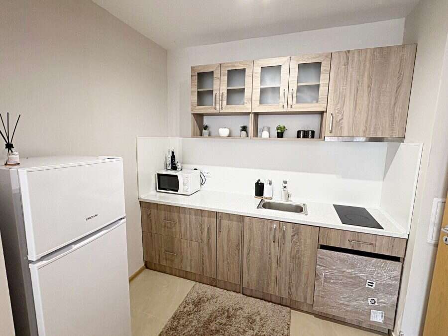 Bright kitchen with modern cabinets and appliances.