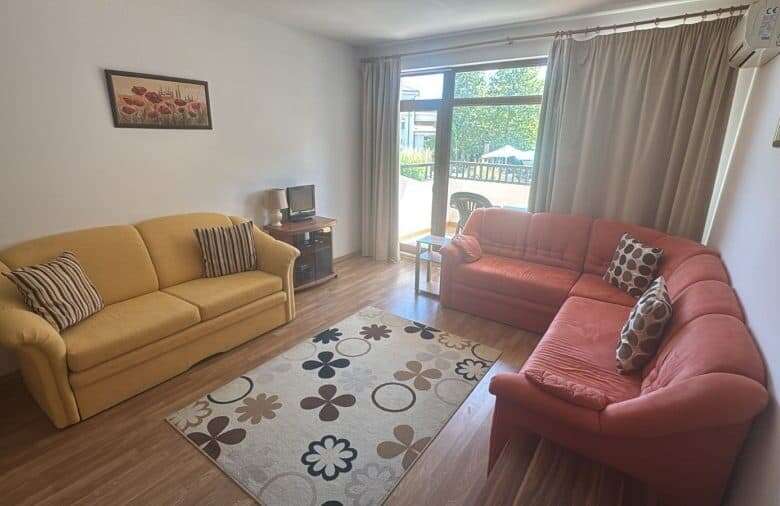 Bright living room with two sofas and a balcony view.