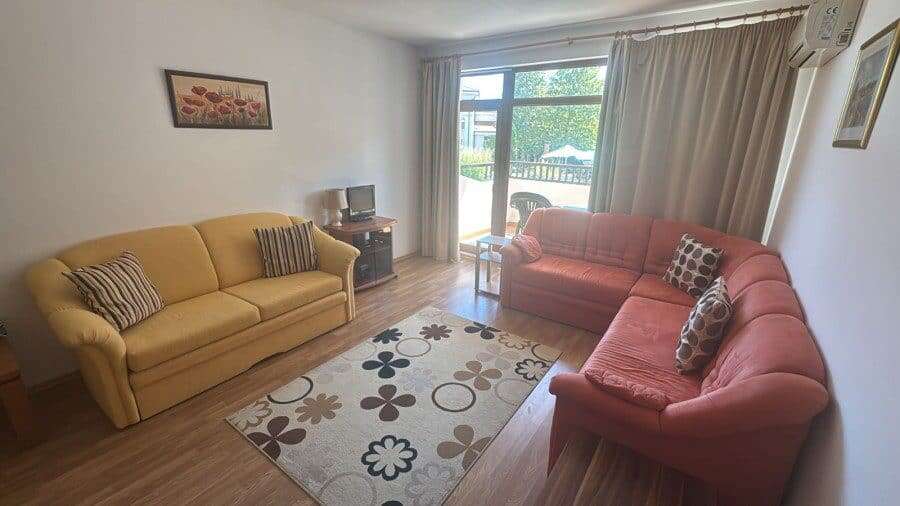 Cozy Living Room in Vineyards SPA Resort Bright living room with two sofas and a balcony view.