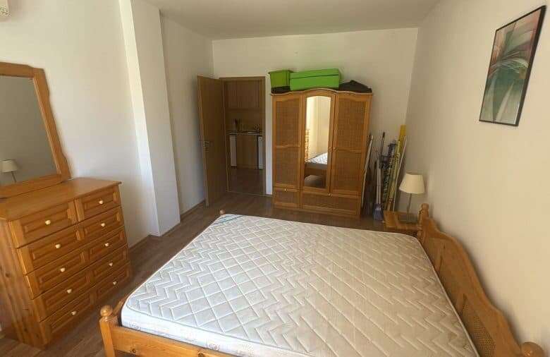 Bright bedroom with wooden furniture and a large bed in Vineyards SPA Resort.