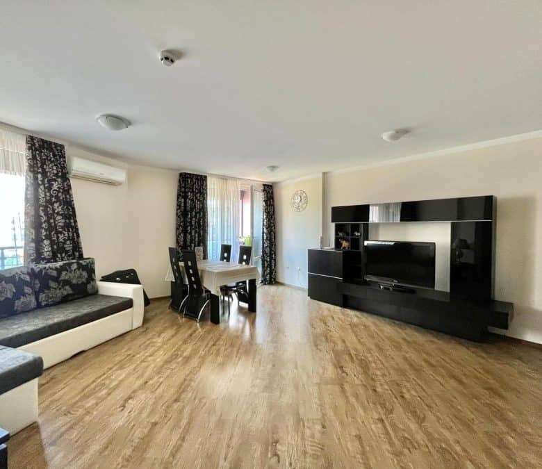 Bright living room with stylish furniture and large windows near the sea.