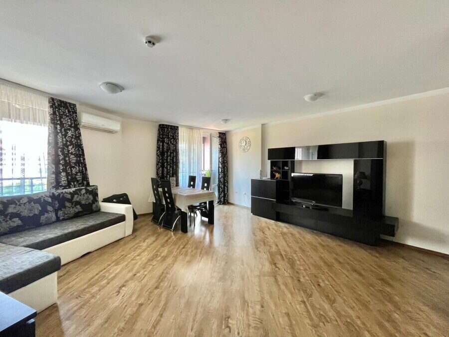 Bright living room with stylish furniture and large windows near the sea.