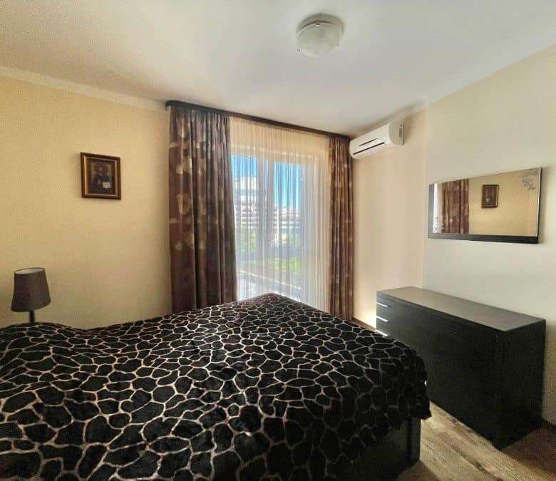 Interior of a 1-bedroom apartment in Sunny Beach Plaza, 100m from the sea, with a bed, window, and s.