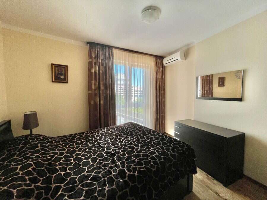 Interior of a 1-bedroom apartment in Sunny Beach Plaza, 100m from the sea, with a bed, window, and s.