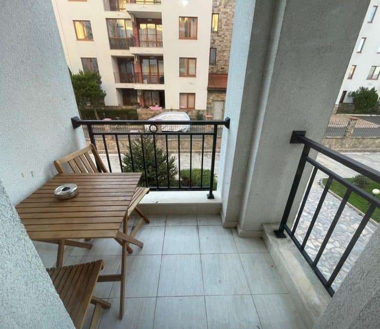 Balcony overlooking garden in Apollon apartments, Ravda. Perfect for relaxing and enjoying outdoor s.