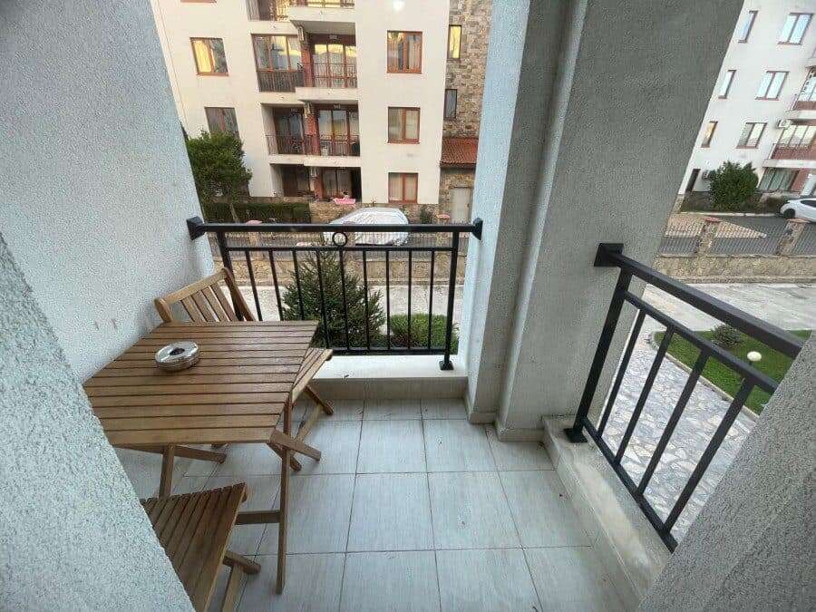 Balcony overlooking garden in Apollon apartments, Ravda. Perfect for relaxing and enjoying outdoor s.