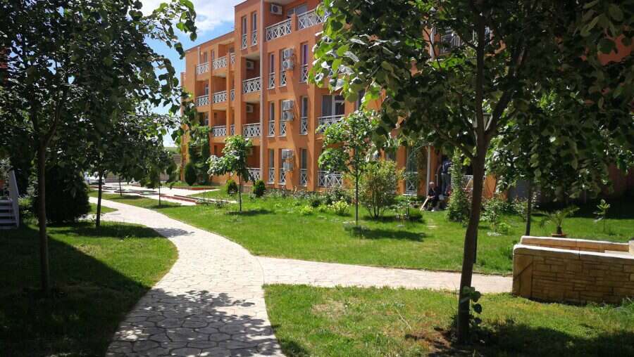 Sunny Day 6 studio building in Sunny Beach with lush green surroundings.