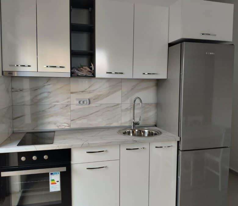 Modern studio kitchen with white cabinets and marble backsplash in Blue Summer complex, Sunny Beach,.