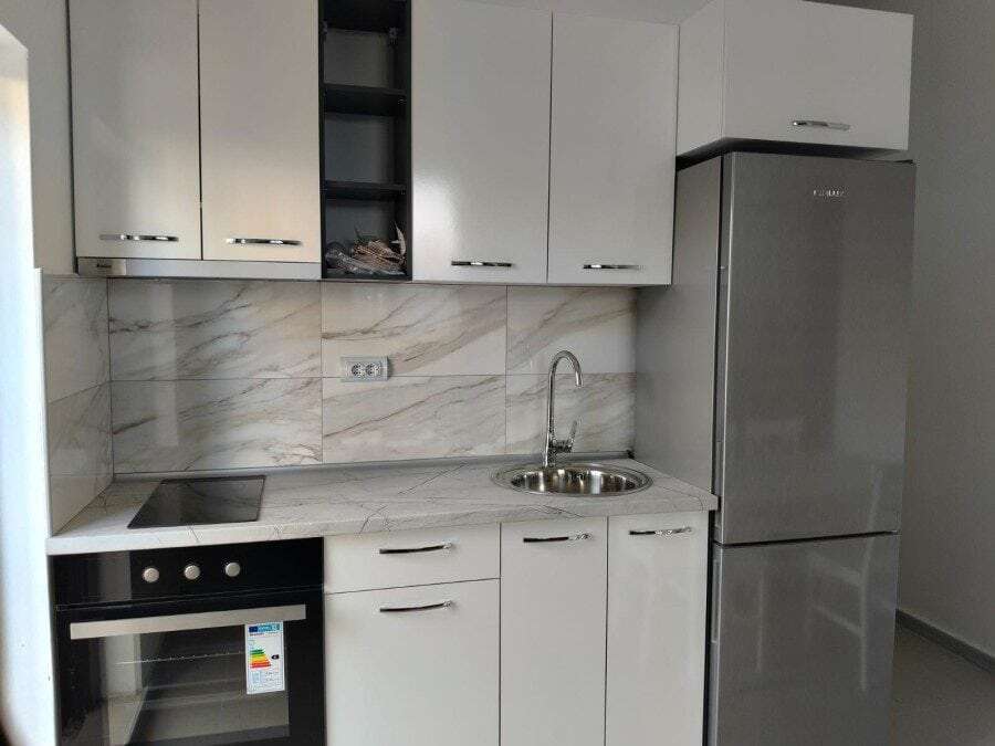 Modern studio kitchen with white cabinets and marble backsplash in Blue Summer complex, Sunny Beach,.