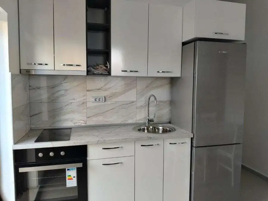 Modern studio kitchen with white cabinets and marble backsplash in Blue Summer complex, Sunny Beach,.