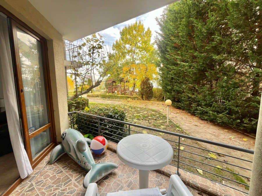 First sea line! 2 BED apartment, 95 sq.m., for sale in Global city, Nessebar Sea view balcony with outdoor furniture overlooking lush greenery and trees.