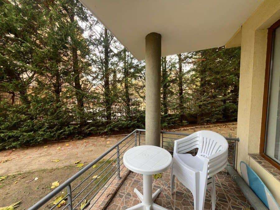 Sea View 2-Bed Apartment in Nessebar Sea view 2-bedroom apartment in Nessebar, Bulgaria, with balcony overlooking lush greenery.