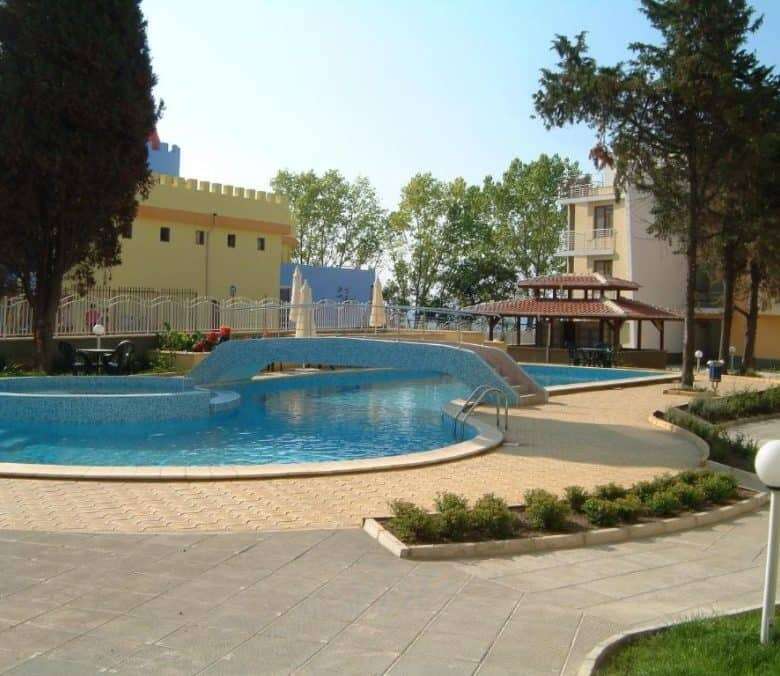 Beachfront pool and garden view in Nessebar's Global City residential complex.