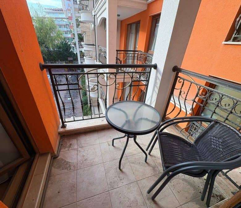 Balcony with two chairs and small round table overlooking the vibrant Sunny Beach area.