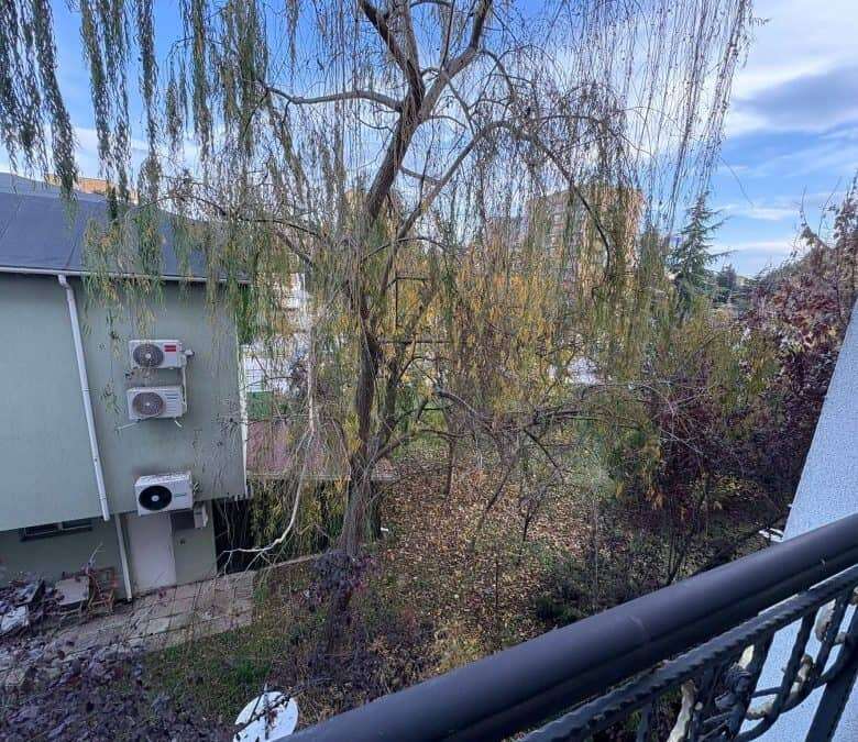 Balcony view of trees and garden area from a 2 bed, 2 bath apartment in Sunny Beach.