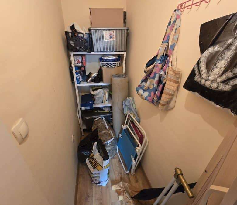 Compact storage space with shelves and household items in Ravda.