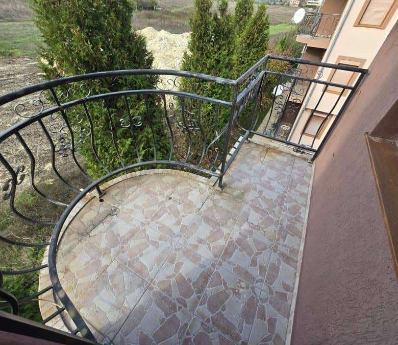 Balcony of a fully furnished 1-bedroom apartment near Ravda beach, featuring decorative tile floorin.