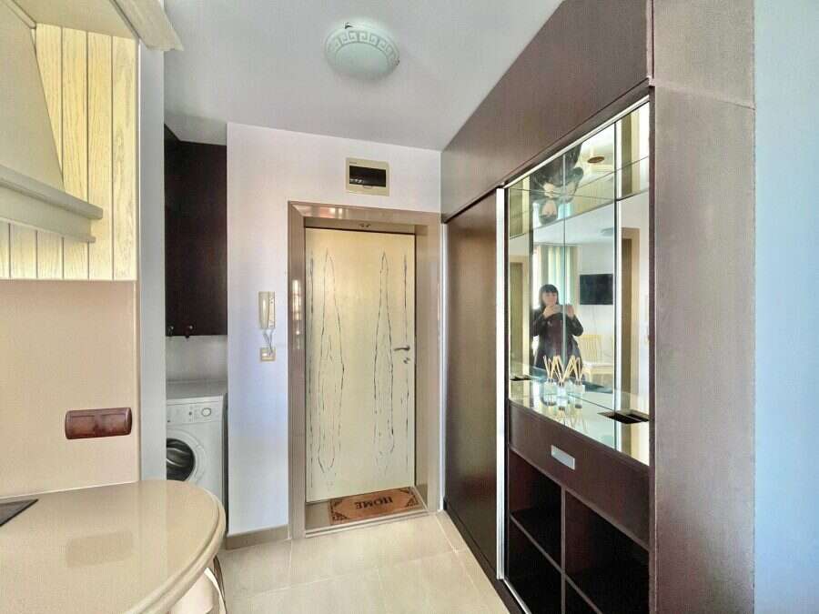 Modern 1-Bedroom Apartment Near Nessebar Beach Interior view of a modern 1-bedroom apartment close to Nessebar beach, featuring a compact living sp.