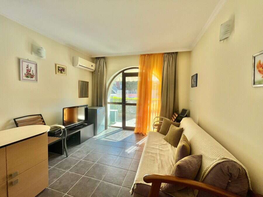 Bright interior with balcony and comfortable furnishings.
