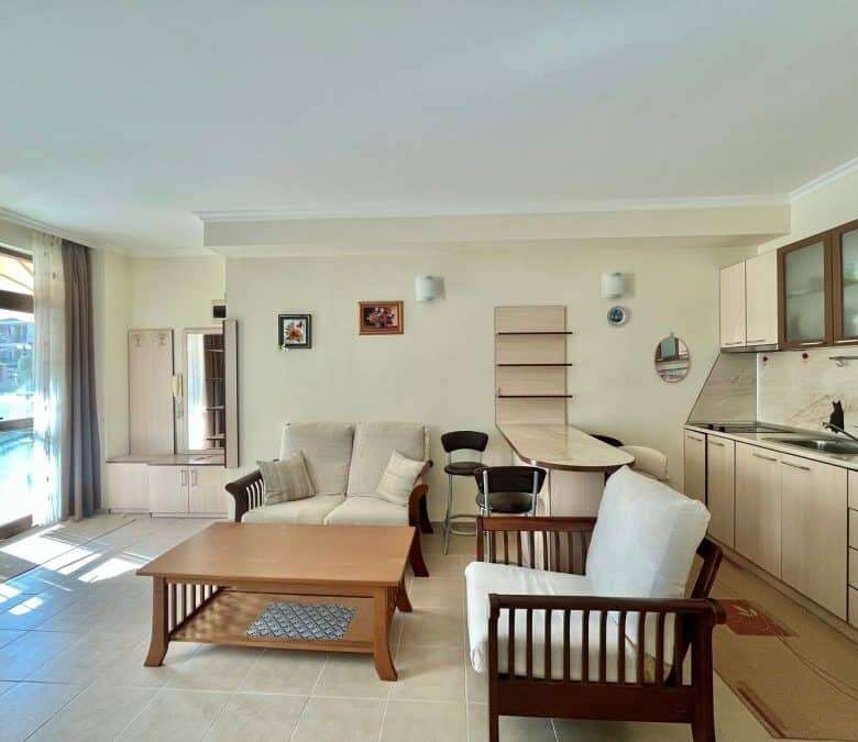 Ground floor apartment living room with sofa, armchairs, and open kitchen in Sveti Vlas.