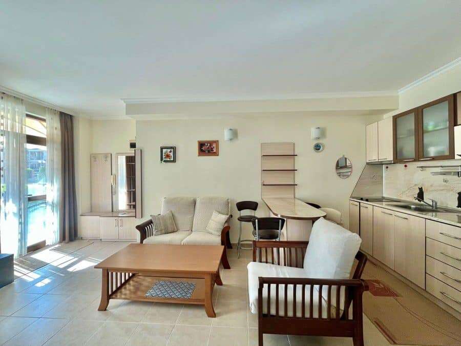 Ground floor apartment living room with sofa, armchairs, and open kitchen in Sveti Vlas.