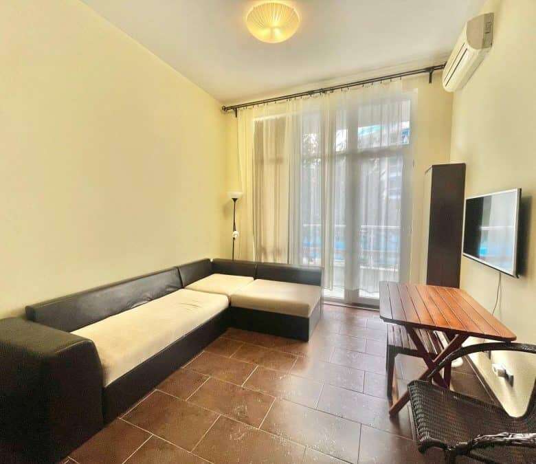 Bright living area with sofa and large window.