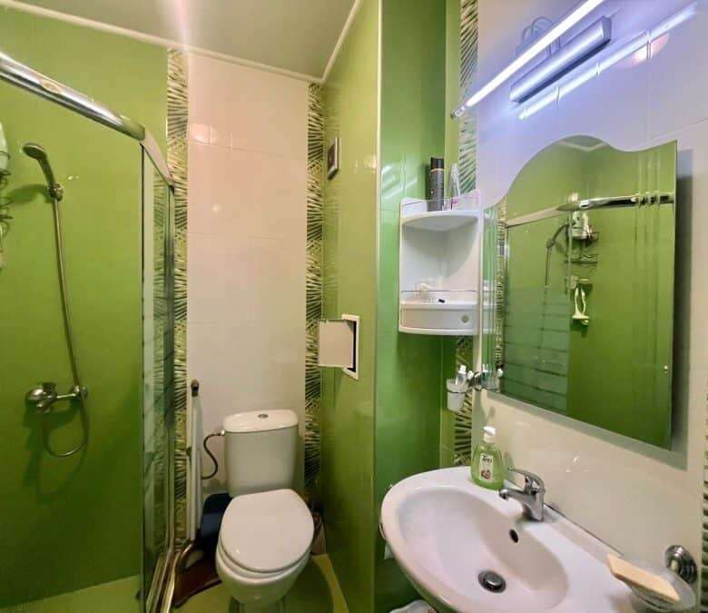 Compact studio apartment with pool view, modern bathroom, and essential amenities in Nessebar.