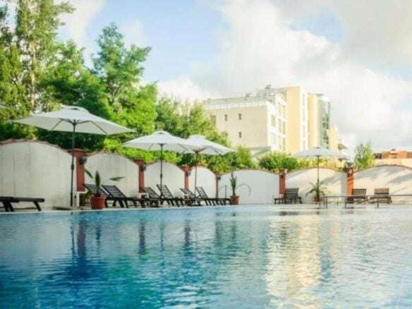 Poolside view with umbrellas and lounge chairs at a modern resort.
