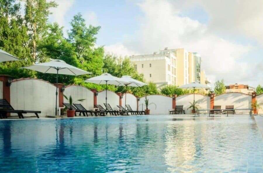 Poolside view with umbrellas and lounge chairs at a modern resort.