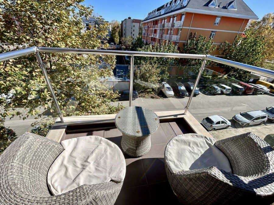 Cozy Balcony View in Tarsis – Club & Spa Balcony with seating overlooking Sunny Beach and surrounding buildings. Perfect for relaxing in a 1-.