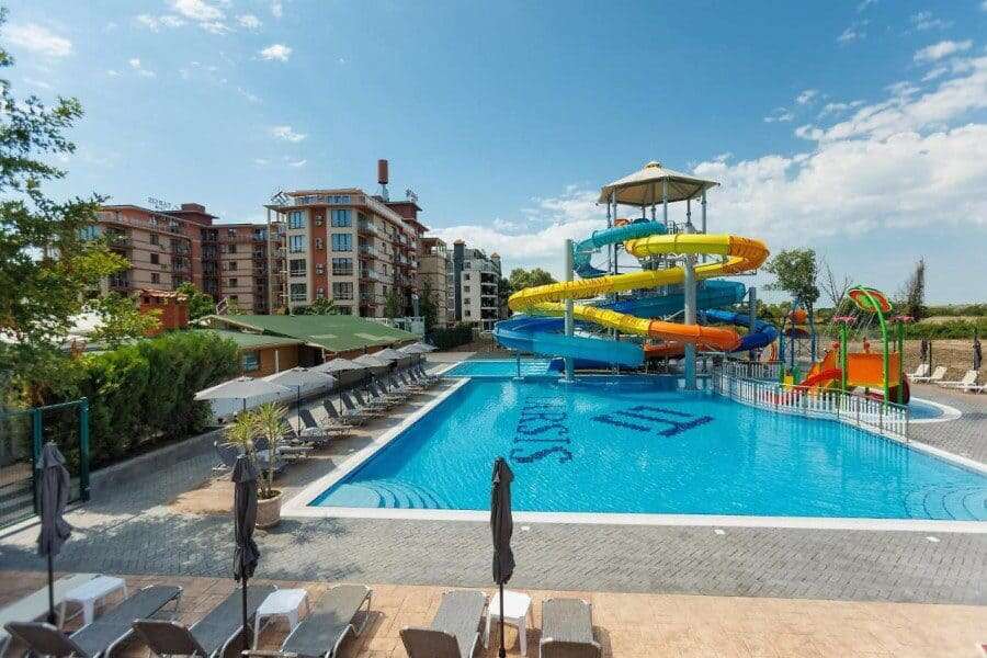 Bright outdoor pool with water slides at Tarsis - Club & Spa, Sunny Beach.