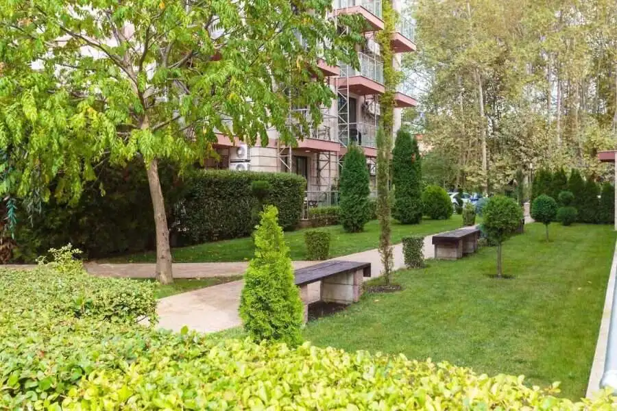 Modern Tarsis apartment garden with lush greenery and walking paths. Beautiful outdoor area of a 2 bed, 2 bath apartment in Tarsis - Club & Spa, Sunny Beach.