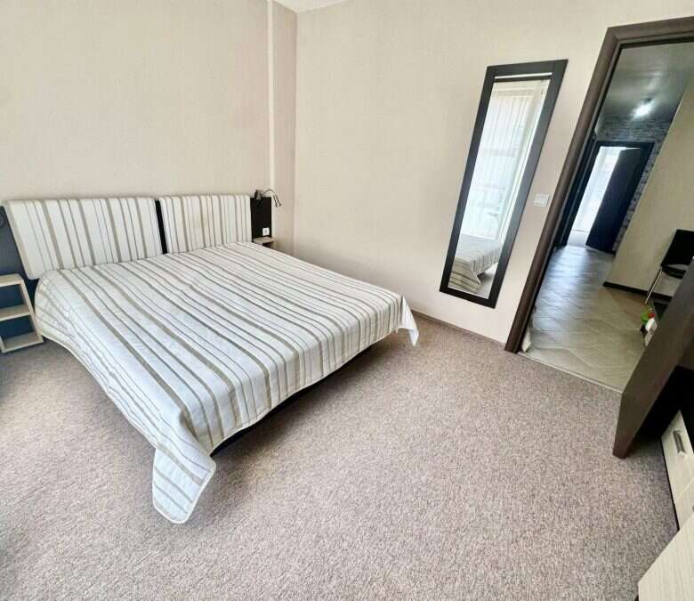 Cozy bedroom with double bed and mirror in Tarsis - Club & Spa, Sunny Beach.
