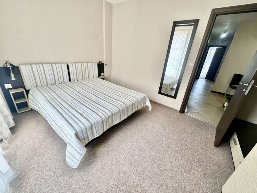 Cozy bedroom with double bed and mirror in Tarsis - Club & Spa, Sunny Beach.
