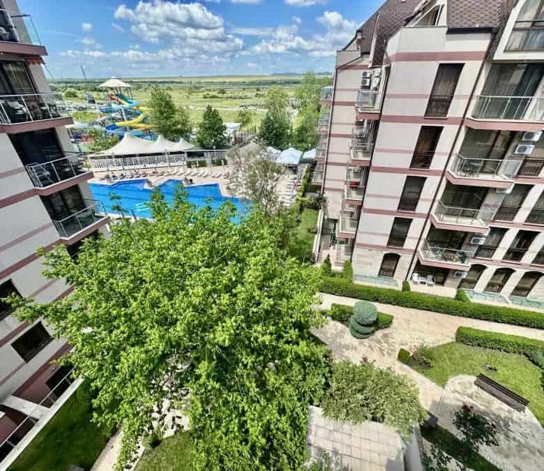 Pool and garden view from Tarsis apartment balcony.