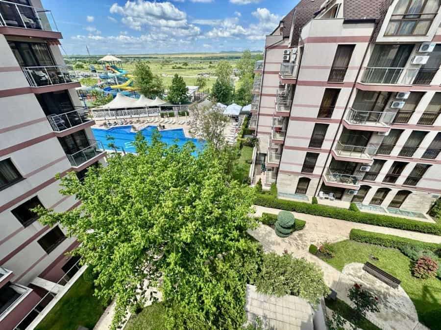 Pool and garden view from Tarsis apartment balcony.