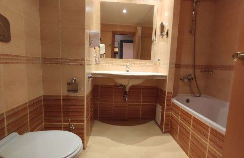 Bright bathroom with bathtub, sink, and modern fixtures in a seaside apartment.