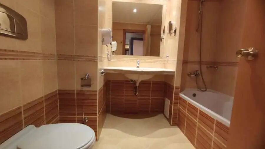 Modern bathroom with bathtub and sink in beachfront apartment Bright bathroom with bathtub, sink, and modern fixtures in a seaside apartment.