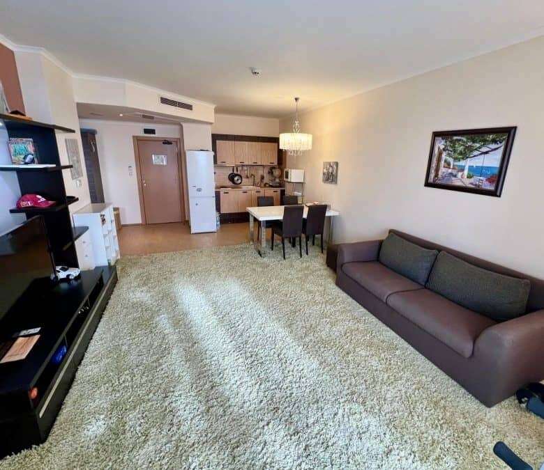 Bright living room with large windows overlooking the sea in Sunny Beach.