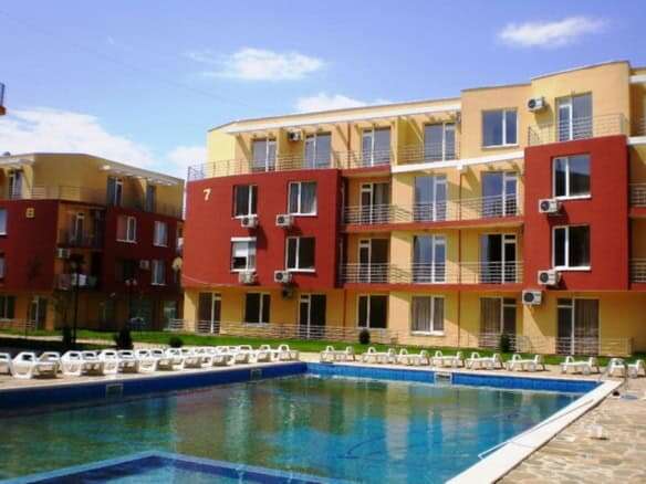 Apartment building with colorful exterior in Sunny Day 5 community.