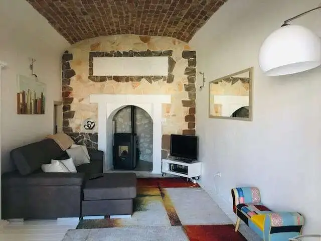 Chiaramonti Sardinia home with cozy living room and rustic fireplace. Perfect for comfortable living.