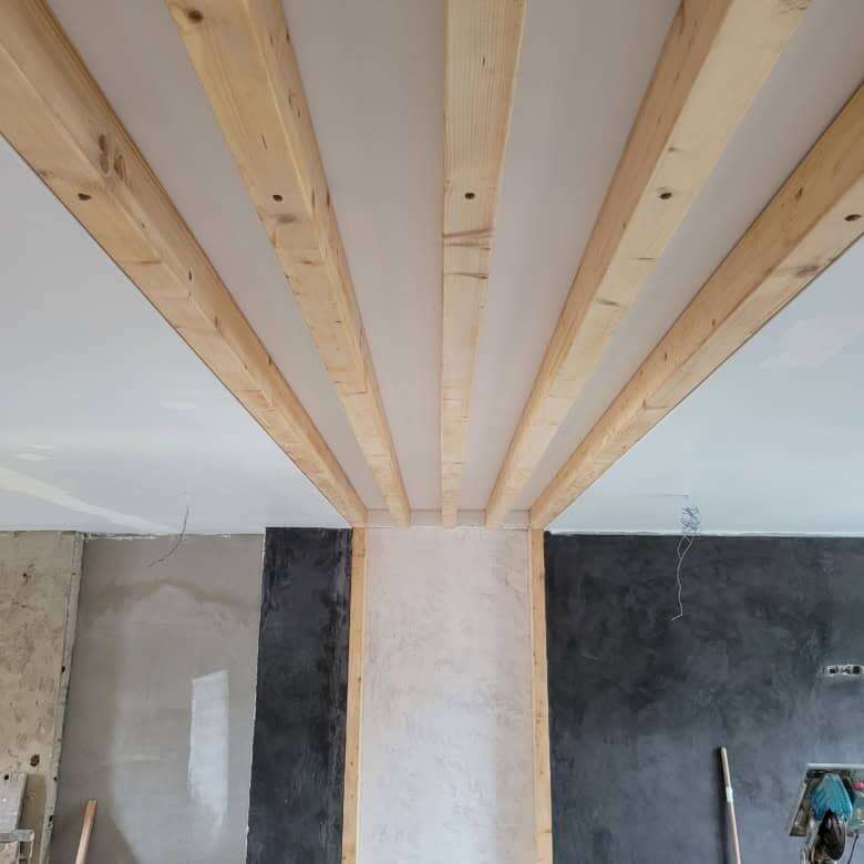 Ceiling framework with wooden beams in a luxury villa under construction.