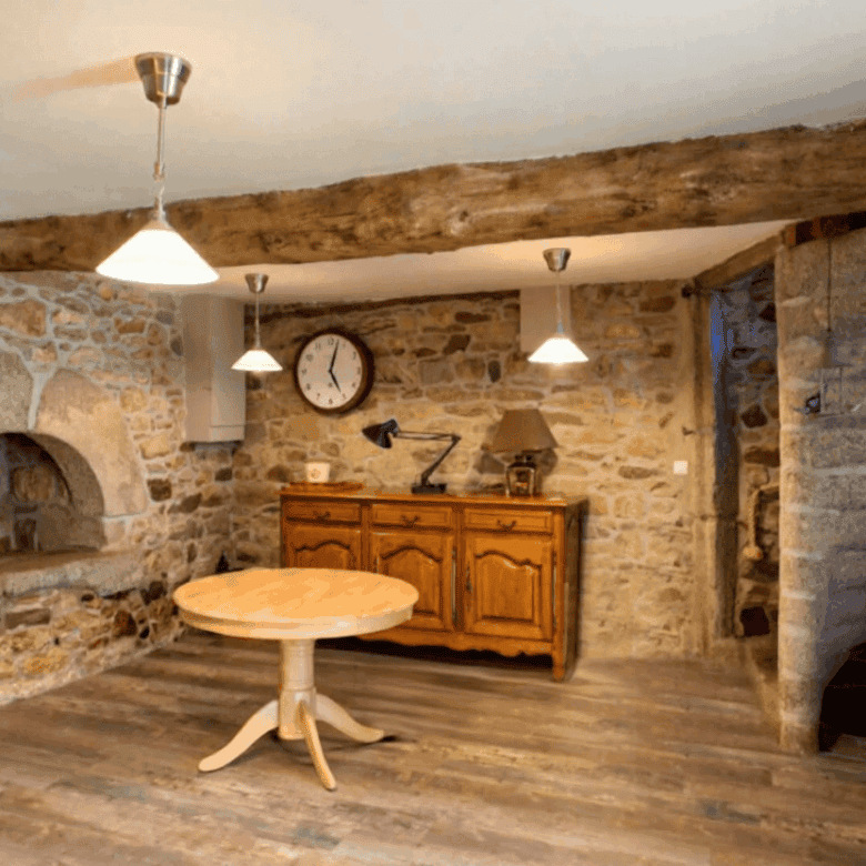 Walled interior with wooden accents in a Brittany gite complex for sale. Perfect for a peaceful coun.