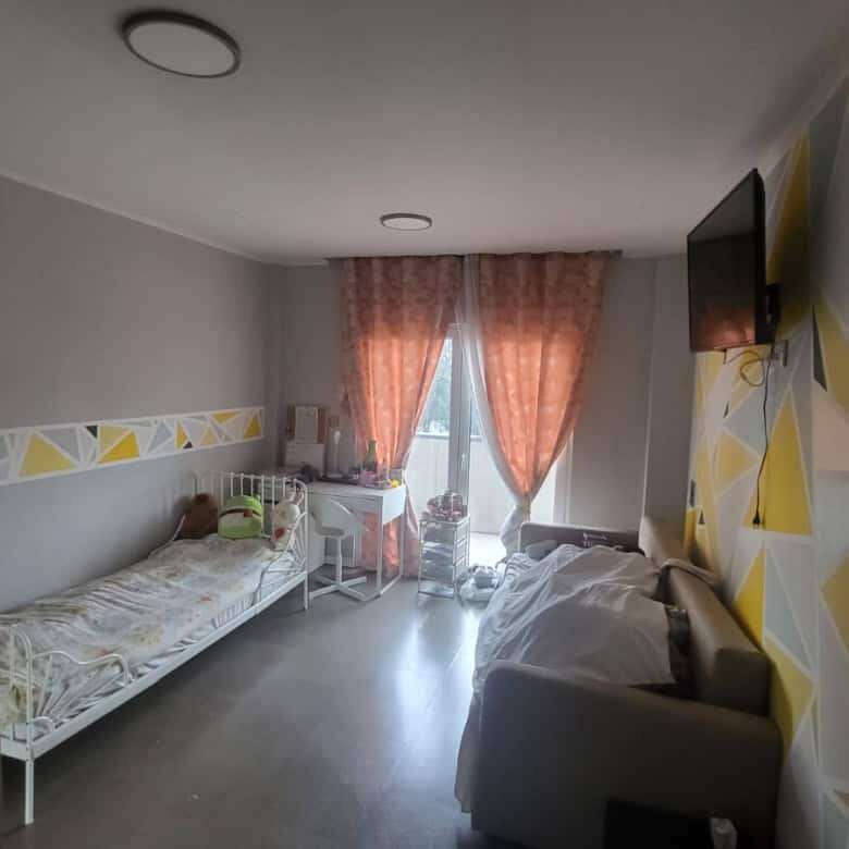 Bright bedroom in a modern villa in Setubal with stylish decor and natural light.
