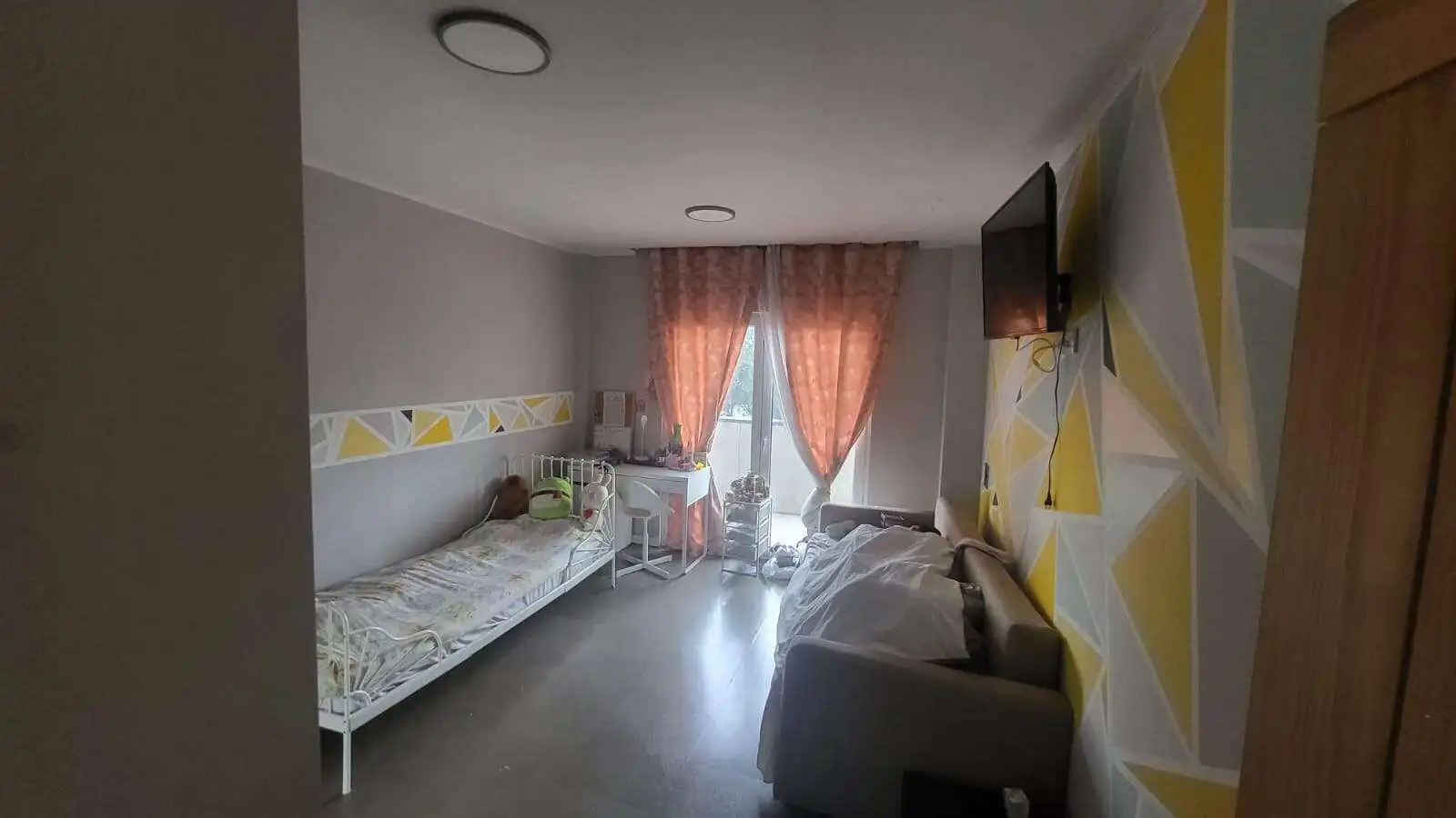 Bright bedroom in a modern villa in Setubal with stylish decor and natural light.